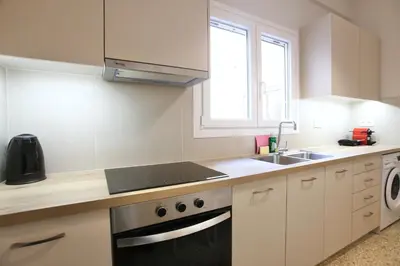 a kitchen with a sink and a stove at Cosy Nektariou in Athens