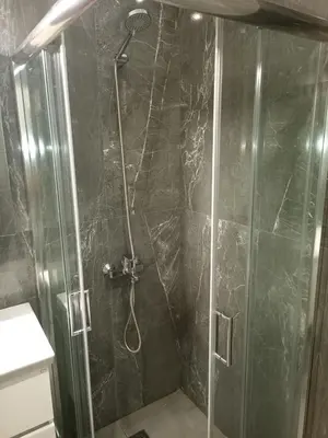 a shower with a glass door in a bathroom at Cosy Nektariou in Athens