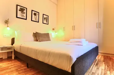 a bedroom with a large bed in a room at Cosy Nektariou in Athens