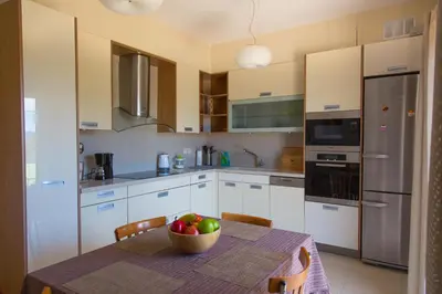 a kitchen with a table with a bowl of fruit on it at Villa Anemos in Dhaskalión