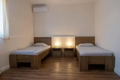 two beds in a room with two lights on at Villa Anemos in Dhaskalión
