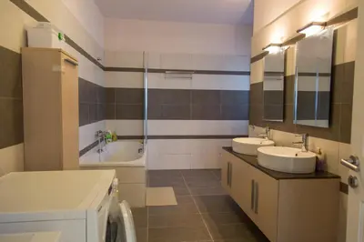 a bathroom with two sinks and a tub at Villa Anemos in Dhaskalión