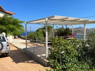 a parking lot with a pavilion with a car parked at Villa Anemos in Dhaskalión