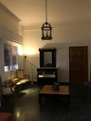a living room with a table and a mirror at Graffiti Ground Floor in Athens