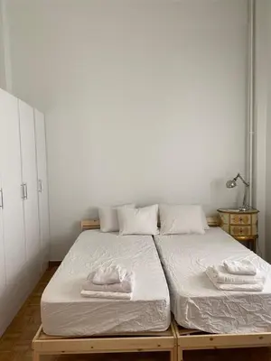 a bedroom with a bed with two towels on it at Graffiti Ground Floor in Athens