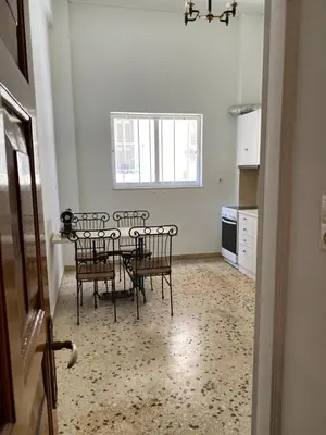 a dining room with a table and chairs in a kitchen at Graffiti Ground Floor in Athens