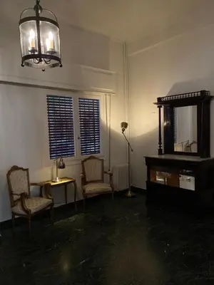 a living room with two chairs and a mirror at Graffiti Ground Floor in Athens