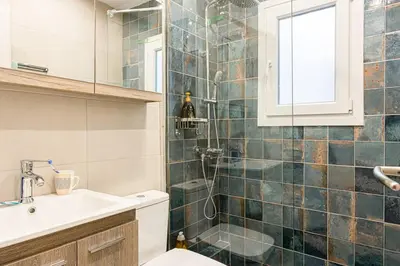 a bathroom with a shower and a sink and a toilet at Heart of Koukaki flat, 10’ walk to Acropolis in Athens