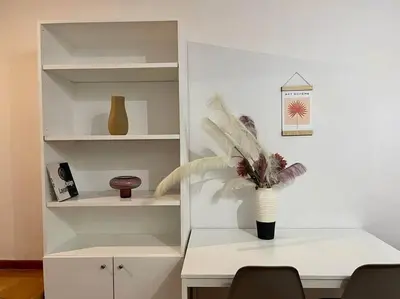 a white desk with a vase with a plant on it at The Love Nest at Central Athens Kolonaki in Athens
