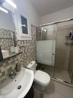 a bathroom with a toilet and a sink and a shower at The Love Nest at Central Athens Kolonaki in Athens