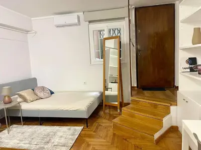 a small room with a bed and a stair case at The Love Nest at Central Athens Kolonaki in Athens