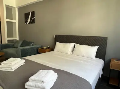 a bedroom with a bed with towels on it at Acropolis View Apartment Athens Downtown in Athens