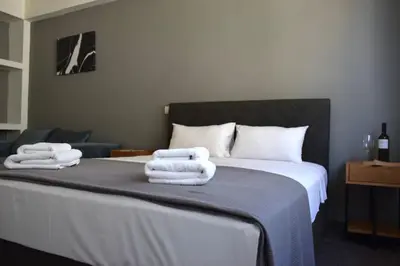 a bedroom with a bed with towels on it at Acropolis View Apartment Athens Downtown in Athens