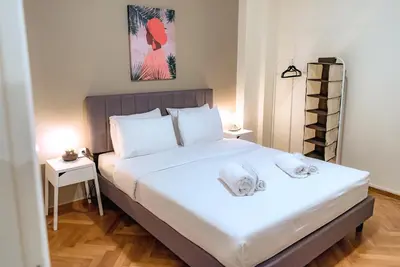 a bedroom with a large white bed with two pillows at Plaka Apartment in Athens