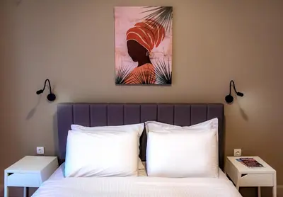a bedroom with a bed with two white pillows at Plaka Apartment in Athens