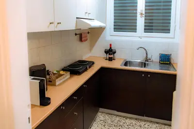 a kitchen with a sink and a counter top at Plaka Apartment in Athens