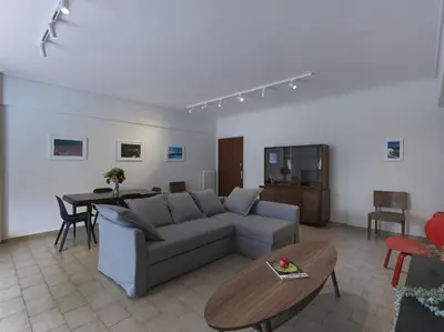 a living room with a couch and a table at 2 bedroom apartment close to children's hospital in Athens