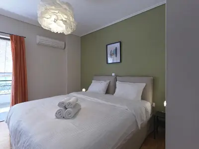 a bedroom with a bed with two teddy bears on it at 2 bedroom apartment close to children's hospital in Athens