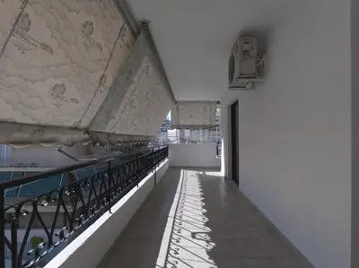 an empty corridor of a building with a balcony at 2 bedroom apartment close to children's hospital in Athens