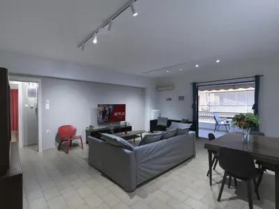 a living room with a couch and a table at 2 bedroom apartment close to children's hospital in Athens