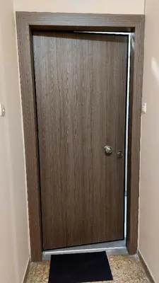 a wooden door in the corner of a room at Cozy Nest in Athens