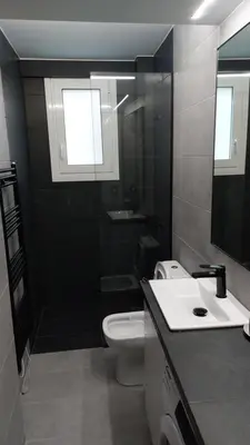 a bathroom with a toilet and a sink at Cozy Nest in Athens