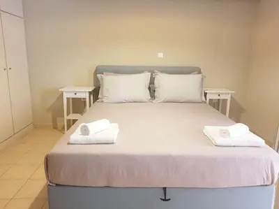 a bed with two white towels on top of it at Athens Campus Renovated Studio Apartment @ Ilisia in Athens