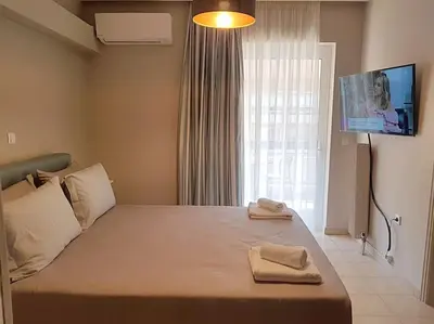 a bedroom with a large bed with two towels on it at Athens Campus Renovated Studio Apartment @ Ilisia in Athens