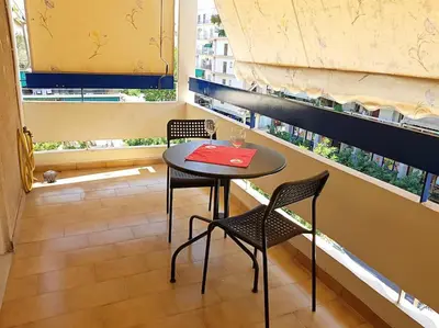 a table and chairs in a room with a window at Athens Campus Renovated Studio Apartment @ Ilisia in Athens