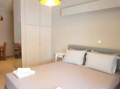 a bedroom with a bed with white pillows at Athens Campus Renovated Studio Apartment @ Ilisia in Athens