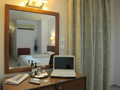 a bathroom with a mirror and a laptop on a dresser at Hotel Solomou Athens in Athens