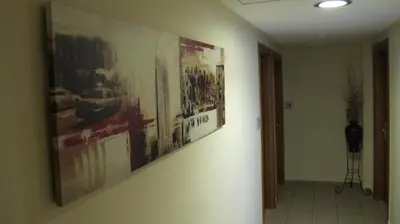 a hallway with posters on the wall of a building at Hotel Solomou Athens in Athens