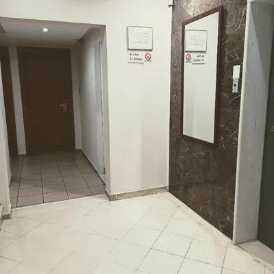 a hallway with a door and a mirror on a wall at Hotel Solomou Athens in Athens