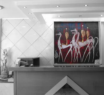 a counter with a painting of animals on the wall at Hotel Solomou Athens in Athens