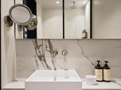 a bathroom with a white sink and a mirror at Electra Rhythm Athens in Athens