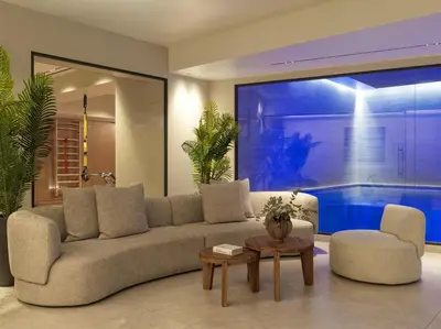 a living room with a couch and a swimming pool at Electra Palace Athens in Athens