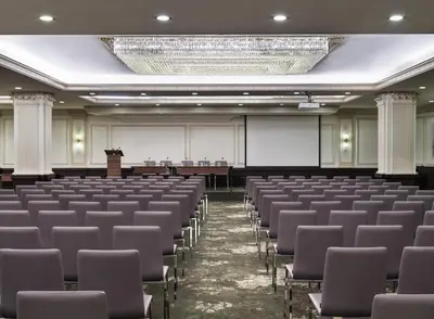 an empty lecture hall with chairs and a chandelier at Electra Palace Athens in Athens