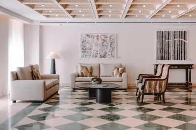 a living room with a couch and a table at Electra Palace Athens in Athens