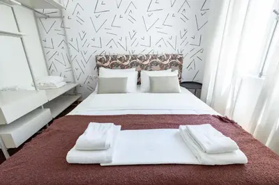 a bedroom with a large bed with white sheets and pillows at An Outstanding 3 bdrm Apartment in the Heart of Athens in Athens
