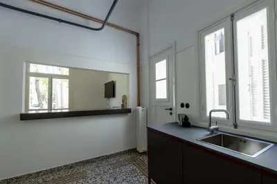a kitchen with a sink and two windows at An Outstanding 3 bdrm Apartment in the Heart of Athens in Athens