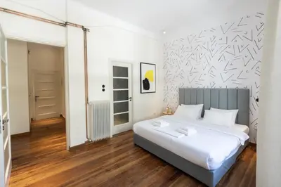 a bedroom with a bed and a wall with black and white patterns at An Outstanding 3 bdrm Apartment in the Heart of Athens in Athens