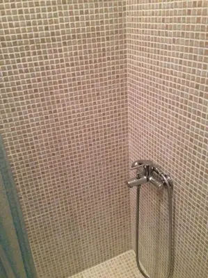 a shower in a bathroom with a tiled wall at Acropolis Steps, City Apartment in Athens