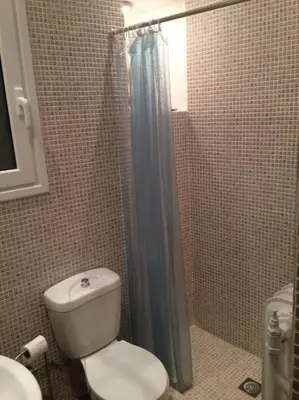 a bathroom with a toilet and a shower at Acropolis Steps, City Apartment in Athens