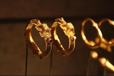 a pair of gold rings on display in a museum at Acropolis Steps, City Apartment in Athens