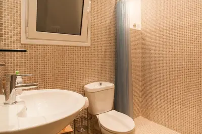 a bathroom with a toilet and a sink at Acropolis Steps, City Apartment in Athens