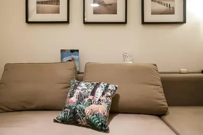 a brown couch with a pillow on top of it at Acropolis Steps, City Apartment in Athens