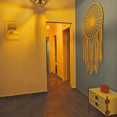 a hallway with yellow walls and a yellow fan on the wall at GAYA apartments in Athens