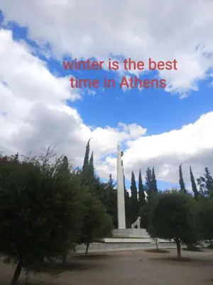 a monument with the words winter is the best time in athens at GAYA apartments in Athens