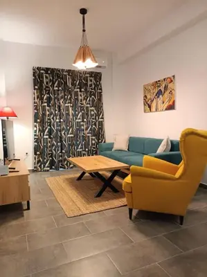 a living room with a couch and a table at GAYA apartments in Athens