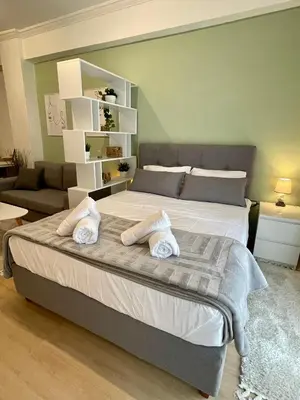 a bedroom with a large bed with two towels on it at Stay Calm in Athens